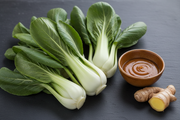 Freshly Harvested Pak Choi with Oyster Sauce and Ginger on Dark Slate