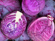 a pile of red cabbage cut in half