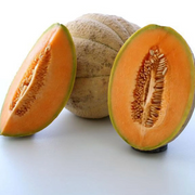 Tuscany cantaloupe melon whole and cut open showing thick salmon-orange flesh, small seed cavity, and tan-brown netted sutured rind